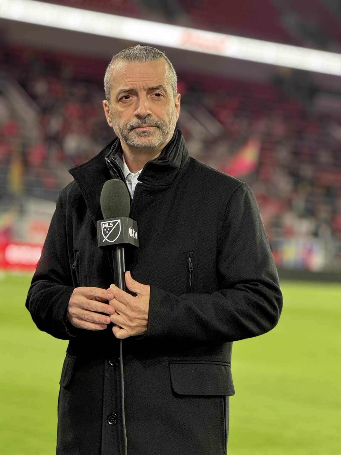 Daniel Chapela on the field with an MLS and Apple TV microphone